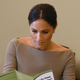 Illustration for article titled Meghan Markle Nervously Looking Over Clinic Pamphlets Weighing Her Options